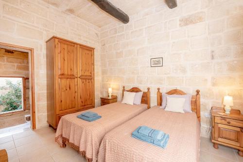 a bedroom with two beds and a window at Casa Melita in Rabat