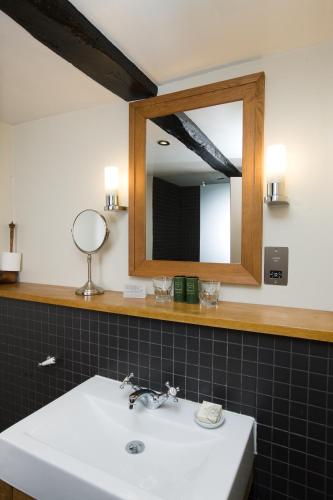a bathroom with a sink and a mirror at Hotel du Vin & Bistro Cambridge in Cambridge