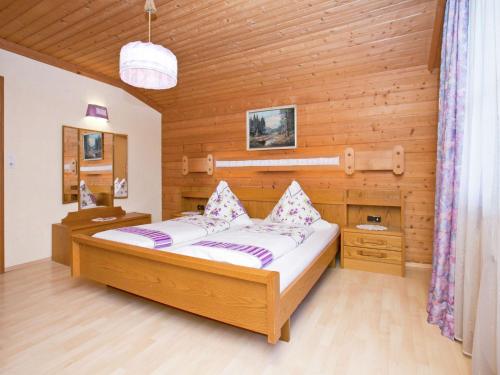 um quarto com uma cama num quarto de madeira em Chalet in Leogang Salzburg with garden em Leogang