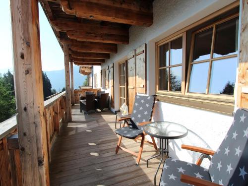 a balcony with chairs and a table and windows at Apartment in Mittersill near the ski area in Mittersill