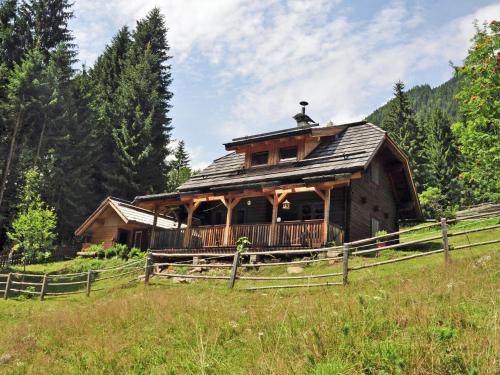 a log cabin in the middle of a field at Inviting Chalet in Kolbnitz Teuchl with Garden and Terrace in Penk