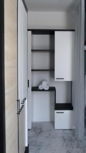 a room with white shelves and a door at Seasides Paris - Suite Monroe in Le Blanc-Mesnil