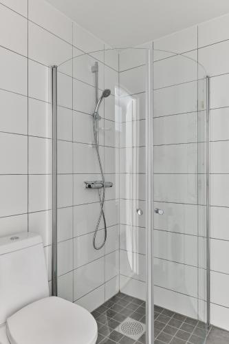 a bathroom with a shower with a toilet at Continental Apartment Hotel Knivsta in Knivsta