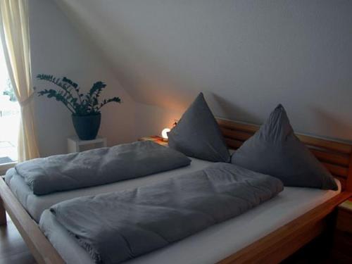 a bed with pillows on it in a bedroom at Landeckhof in Oberwolfach