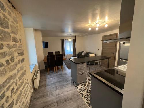 a kitchen with a counter and a dining room at Logement entier : Superbe appartement centre ville in Champagnole