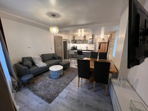 a living room with a couch and a table at Logement entier : Superbe appartement centre ville in Champagnole