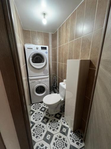 a bathroom with a washing machine and a toilet at Logement entier : Superbe appartement centre ville in Champagnole