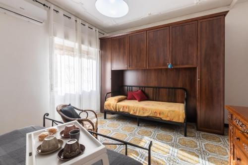 a bedroom with a bed and a table in a room at La casa di Marta in Noto
