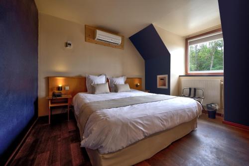 מיטה או מיטות בחדר ב-Auberge de Poteaupré