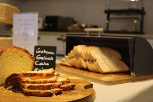 a loaf of bread and a cutting board with bread at Auberge de Poteaupré in Bourlers