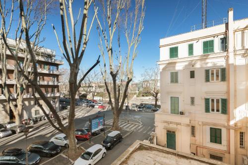a city street with cars parked in a parking lot at R.C. Giulio Cesare. Loft in centro in Rome