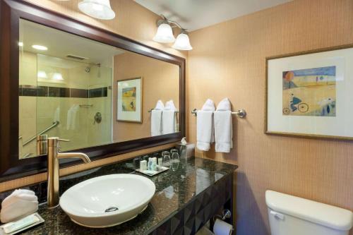 a bathroom with two sinks and a mirror at Wyndham Grand Pittsburgh in Pittsburgh