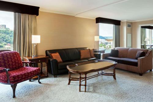 a living room filled with furniture and a couch at Wyndham Grand Pittsburgh in Pittsburgh