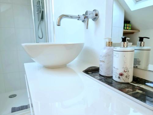 a bathroom with a white bowl sink on a counter at West Hill Retreat Seaview Balcony Self Catered Loft Studio & Free Offstreet Parking in Hastings