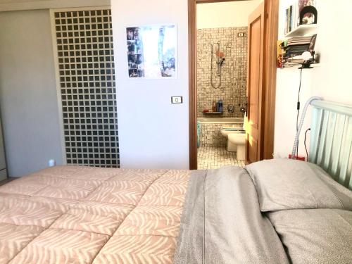 ein Schlafzimmer mit einem Bett und ein Badezimmer mit einem WC in der Unterkunft B&B Curva della Palma in San Marino