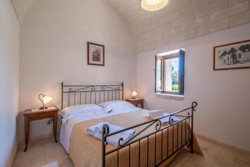 Кровать или кровати в номере Trulli Oasi Fiorita - Exclusive Apulian Holidays