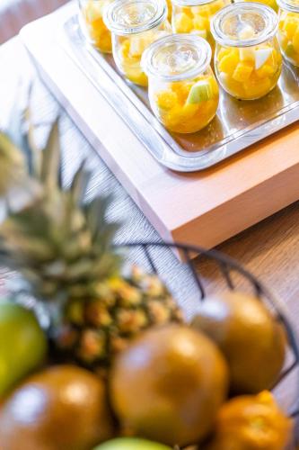 a tray of fruit on a table with a tray of oranges at Le Rive Sud in Estavayer-le-Lac