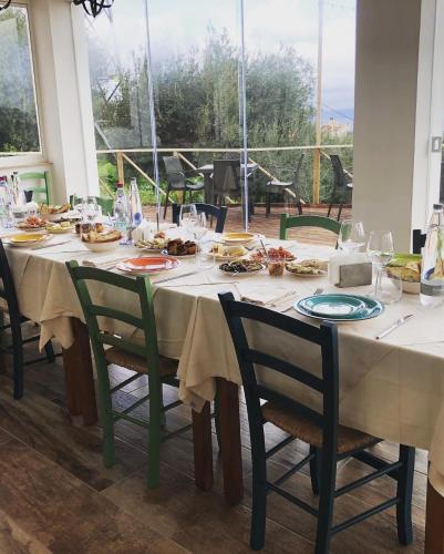 a table with plates of food on top at mammaCristina in Patti