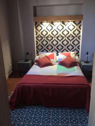 1 dormitorio con 1 cama grande y cabecero de madera en Le Mondrian atypique Intra-Muros, en Aviñón