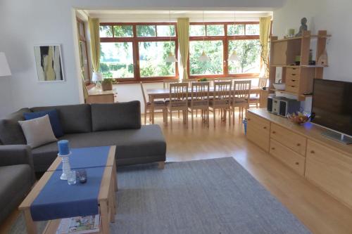 a living room with a couch and a tv at Villa Schnuck - das rote Ferienhaus in Bad Gastein