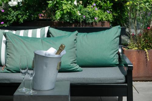 a bench with a bottle of wine and glasses on a table at Nimb Hotel in Copenhagen