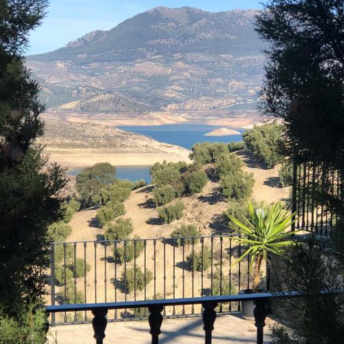 a view of a body of water from behind a fence at Cortijo Rocas Altas in Iznájar
