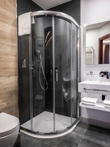 a shower in a bathroom with a toilet and a sink at Hotel Europa Starachowice in Starachowice
