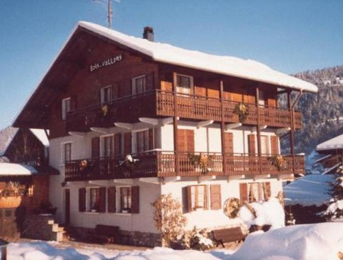 a large building in the snow with snow at Chalet Bois Vallons Chambres d'Hôtes in Morzine