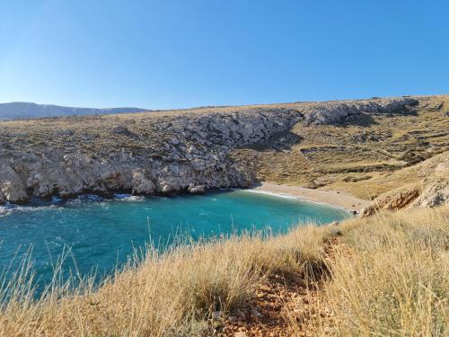 a blue pool of water in the middle of a hill at Boutique Resort OSMA - Adults Only in Malinska