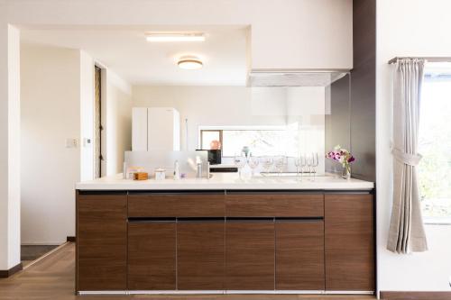 una cucina con un lavello e un piano di lavoro di Keiko"s Home 宮浦一日一組限定海の絶景オーシャンビューのラグジュアリー別荘2000m2BBQ可海釣公園 a Fukuoka