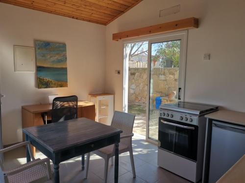 a kitchen with a table and a stove top oven at Wooden House in Paphos City