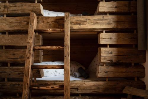 a wooden bunk bed in a room at Wochenbrunner Chalets in Ellmau