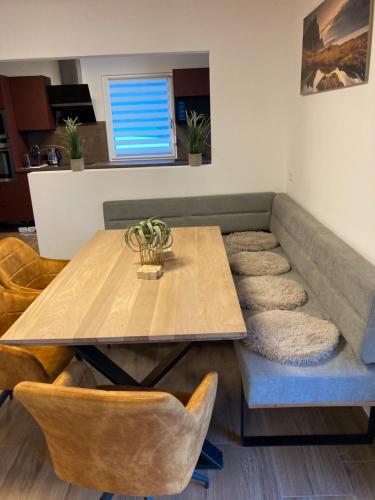 a dining room with a wooden table and chairs at Chalet Bergblick in Sankt Blasen