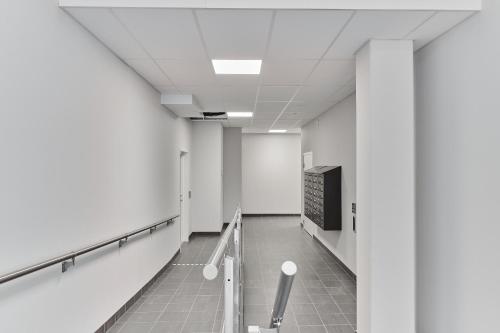 a hallway of an office building with a chalkboard on the wall at Continental Apartment Hotel Knivsta in Knivsta