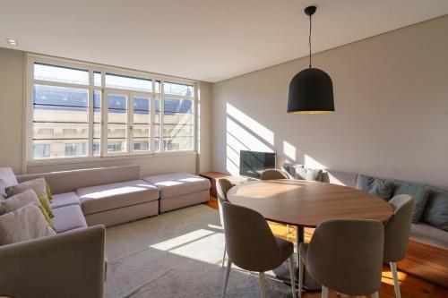 a living room with a table and a couch at N Apartments - Bolhão in Porto