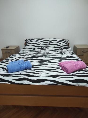 a black and white bed with two pillows on it at Fortuna in Vrdnik