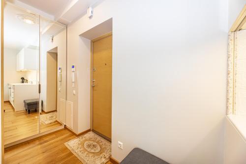 a hallway with a door leading into a room at A&A Palanga Apartments in Palanga