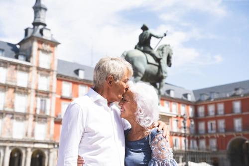 a man and a woman standing in front of a statue at Ocean Drive Madrid in Madrid