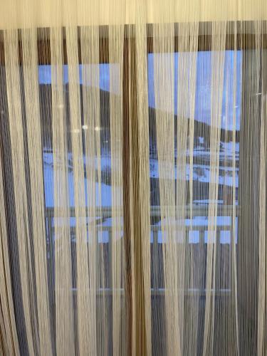 a view of the sky through a window with curtains at Honey Valley Bjelašnica in Bjelašnica