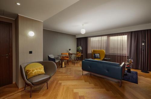 a living room with a couch and a chair at Reykjavik Natura - Berjaya Iceland Hotels in Reykjavík