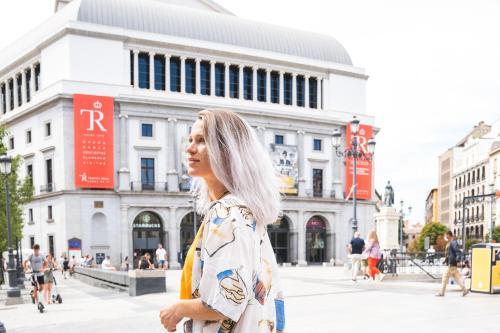 a woman standing on a street in a city at Ocean Drive Madrid in Madrid