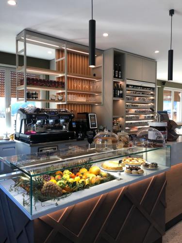 a display case in a restaurant with fruits and vegetables at ALPieve Albergo Pieve in Ledro