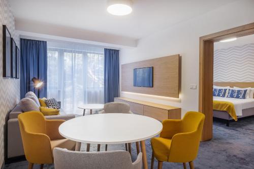 a hotel room with a table and chairs and a bed at Best Western Hotel Jurata in Jurata