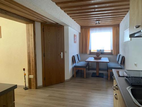 a kitchen and dining room with a table and chairs at Haus Hermi in Nesselwängle
