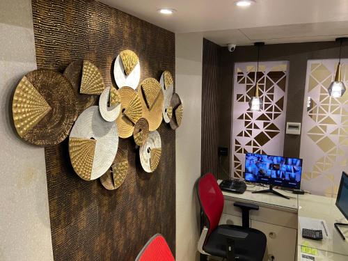 an office with a desk with a computer on a wall at Dash Hotels - Affordable Luxury in Hyderabad