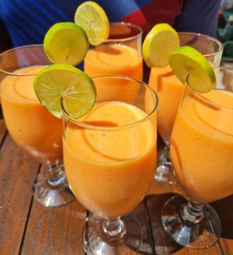 a group of glasses filled with orange juice at Villa Talpe in Talpe