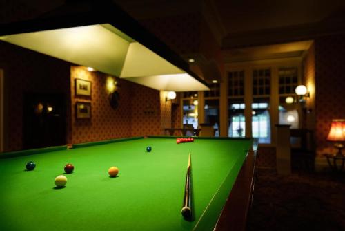a pool table with balls on top of it at Mansion House Hotel in Elgin