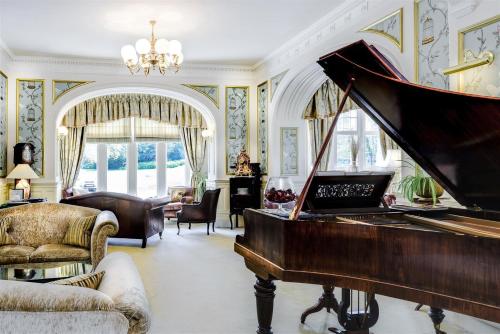 a room with a piano and a living room at Mansion House Hotel in Elgin