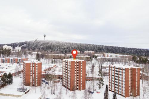 a red sign on top of a building in the snow at 2 Bedroom apartment with free parking and airconditioning in Kuopio