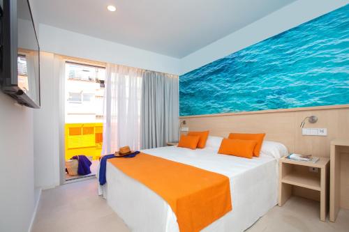 a bedroom with a bed with a painting on the wall at Mix Smart in El Arenal